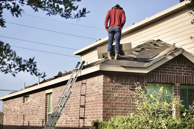 Professional roofer working on a residential roof in Rockwell